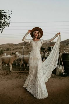 a woman in a white dress and cowboy hat