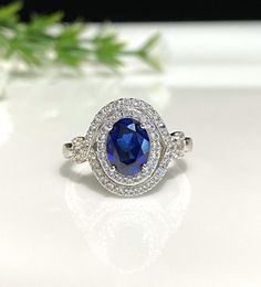 Vintage Sterling Silver Oval cut Blue Sapphire & White Topaz Ring....Marked 925...Total of weights 3.3gramsSize 7.25....Measure of Sapphire 8 x 6MM...It's in very good condition. Blue Oval Birthstone Ring With Halo Setting, Blue Oval Sterling Silver Birthstone Ring, Blue Oval Birthstone Ring In Sterling Silver, Dazzling Blue Sapphire Ring In Sterling Silver, Dazzling Blue Sapphire Sterling Silver Ring, Dazzling Blue Sterling Silver Rings, Classic Blue Sterling Silver Halo Ring, Oval Blue Crystal Ring For Anniversary, Blue Oval Crystal Ring In Sterling Silver