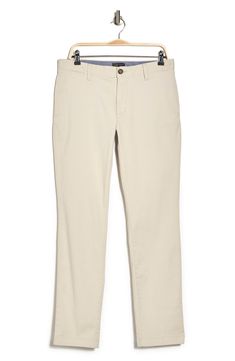 A solid hue makes these chino pants a versatile, everyday classic staple for your closet. 9" rise, 32" inseam (size 32x32) Trim fit Zip fly with button closure 2 front slash pockets; 2 back button welt pockets 97% cotton, 3% spandex Machine wash, tumble dry Imported Model stats: 6'1" height, 32" waist. Model is wearing size 32x32. Classic Slim Fit Mid-rise Chinos, Slim Fit Mid-rise Classic Chinos, Spring Slim Fit Flat Front Chinos, Beige Slim Fit Straight Leg Chinos, Beige Stretch Chinos With Straight Leg, Beige Stretch Straight Leg Chinos, Spring Straight Leg Chino Cotton Twill Work Pants, Classic Mid-rise Cotton Work Pants, Classic Mid-rise Beige Pants