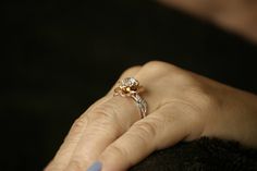 a woman's hand with a ring on it