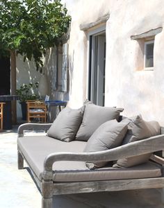 a couch with some pillows on top of it in front of a building and the caption reads, peephhome