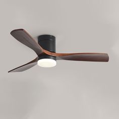 a black ceiling fan with wooden blades and a light on the top one is turned on