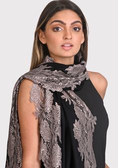 This black scarf is an all time classic with a little bling. Woven from a fine silk and wool blend, it features a contrasting Antique Silver floral lace border making for the perfect any time wear accessory whilst keeping you comfortably warm. For a casual or formal look, this is a must-have in every woman's wardrobe. Fitted Elegant Shawl For Festive Occasions, Elegant Fitted Festive Shawl, Elegant Black Scarf For Festive Season, Elegant Black Scarves For Festive Season, Elegant Black Shawl For Festive Occasions, Elegant Black Festive Shawl, Elegant Black Festive Scarves, Elegant Embroidered Shawl For Festive Season, Elegant Embroidered Shawl For Festive Occasions