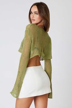 Final Sale - Get it before it's gone! The Halle Green Sheer Knit Crop Top is the cutest going-out top! Fern green ladder knit shapes this cropped sheer top with a boat neckline and long bell sleeves. Style it on or off the shoulder with a micro mini skirt! DETAILS & FIT Loose Fit. Polyester. Machine wash cold. Imported. Spring Green Stretch Knit Top, Green Stretch Knit Top For Spring, Stretch Green Knit Top For Spring, Spring Textured Knit Long Sleeve Crop Top, Spring Open Knit Cropped Sweater With Crew Neck, Long Sleeve Textured Knit Summer Tops, Textured Knit Long Sleeve Tops For Summer, Summer Layering Crop Top With Crew Neck, Cropped Pointelle Knit Tops For Spring