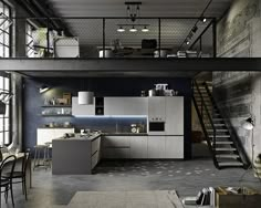 an industrial style kitchen and dining area with stairs leading up to the second floor,