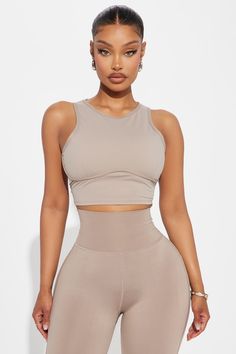 Available In Sage And Taupe. Super Soft Active Top Sleeveless High Neckline Underbust Binding Back Cut Out Ruching Back Tie Pair with "Pilates Girl Active Flare Pant" 75% Nylon 25% Spandex Imported | Pilates Girl Active Top in Taupe size 2X by Fashion Nova