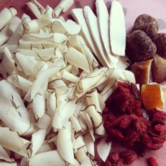 an assortment of dried fruits and vegetables on a cutting board