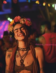 a woman with flowers in her hair smiling