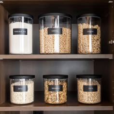 the shelves are filled with different types of cereals and other food in plastic containers