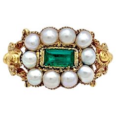 This bright Georgian was ceated in the 1820's. The ring is set with ten natural white oriental half pearls. The pearls are set in a grooved setting that follows the outline of the pearls. The center of the ring head is decorated with a rectangular table cut emerald. The emerald is set in a finely engraved closed gold mount within an outer gold frame. The pierced ring shoulders are executed in high relief and decorated all over with scroll work. Regency Engagement Ring, Georgian Ring, Pearl Rings Vintage, George Iv, Diamond Pendants Designs, Antique Jewelry Rings, Georgian Jewelry, Shiny Objects, Ring Emerald