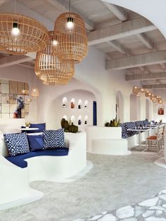 the interior of a restaurant with blue and white decor on the walls, tables and chairs