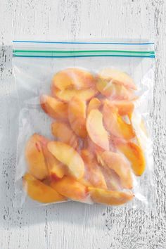 sliced peaches in a plastic bag on a white table