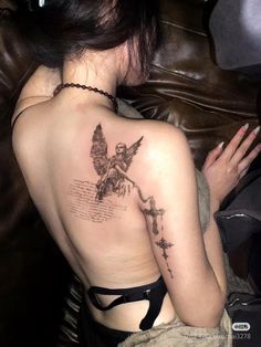 a woman with a tattoo on her back