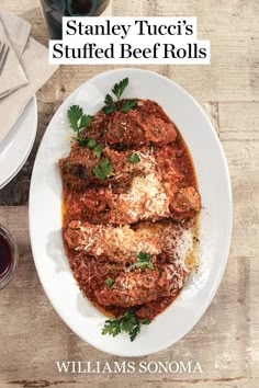 a white plate topped with meat covered in sauce