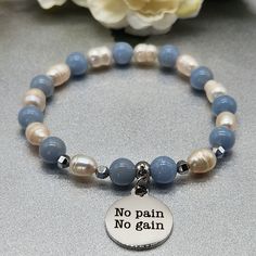 A serene and sporty bracelet featuring angelite beads, freshwater pearls, sleek hematite spacers, and a motivational charm, embodying inner strength and determination with a blend of calm and inspiration.  * 19x22mm stainless steel hypoallergenic lead and nickel-free charm  * 8mm angelite  * 8mm freshwater pearls  * 4mm hematite spacers  * 6mm stainless steel bail  * Stretch bracelet  * 7 1/2 inches wide **CARE INSTRUCTIONS ** To keep your jewelry as beautiful as the day you got them, you can follow these helful tips.   1. Avoid water/moisture 2. Avoid chemicals  3. Limit exposure to sun 4. Wipe with dry microfiber cloth  5. Store in dry, enclosed place Hand-strung Healing Stretch Bracelet, Cheap Hand-strung Spiritual Stretch Bracelet, Angelite Crystal Bracelet, Hand-strung Hematite Stretch Bracelet As Gift, Adjustable Hand-strung Hematite Beaded Bracelets, Gifts For Gym Lovers, Fitness Jewelry, Fitness Bracelet, Pearl Charms