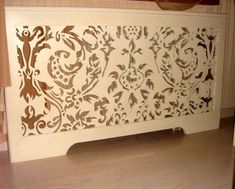 an intricately designed wooden headboard sits on a table