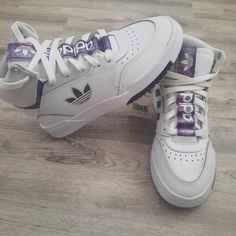 * New, Never Worn * White With Sparkly Purple Detail * Size Is 5.5 Boys/Mens Or Fits 6.5 Womens * No Low Offers Accepted * Same Or Next Day Shipping White Ankle-high Synthetic Skate Shoes, Trendy White Adidas Sneakers, Adidas White High-top Skate Shoes, Trendy White Skate Shoes With Boost Midsole, White Ankle-high High-top Sneakers With Laces, White Ankle-high High-top Sneakers, Adidas Drop Step, Adidas Nizza Platform, Adidas Shoes Nmd