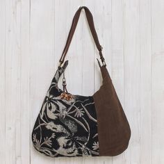 From Thai designer Sansanee Krasae this eye-catching cotton handbag features a floral print inset. In tones of silver deep black and rich brown it opens to reveal a zipper pocket and two open compartments. The zipper pull is adorned with a leather flower. Cheap Bohemian Brown Shoulder Bag, Cheap Bohemian Brown Bags, Hobo Purses And Handbags, Cheap Vintage Bags For Fall, Affordable Vintage Bags For Fall, Hobo International Handbags Vintage, Affordable Vintage Women's Bags, Fair Trade Gifts, Black Reversible Canvas Bag