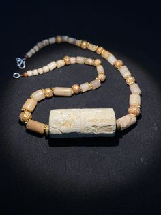 old ancient antique roman cylinder seal with stone age crystals quartz beads by uddiyanaart on Etsy Ancient Handmade Ceremonial Jewelry, Handmade Ancient Ceremonial Jewelry, Handmade Ancient Jewelry For Ceremonial Use, Gold Carved Round Beads Jewelry, Gold Carved Beads Jewelry, Antique Carved Jewelry For Rituals, Ancient Style Gemstone Beads Jewelry Gift, Ancient Style Gemstone Beads Jewelry For Gift, Bohemian Carved Jewelry For Healing