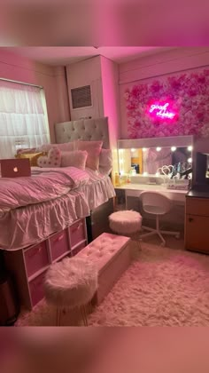 a bedroom with pink lighting and white fur rugs on the floor next to a bed