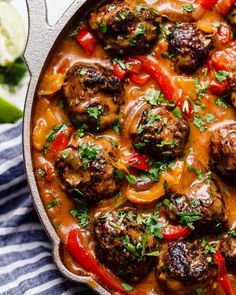 meatballs with red peppers and sauce in a skillet