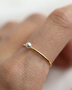 Small Swarovski Pearl Stacking Ring - It's a simple and classic everyday ring that adds a tiny beauty to your finger :) Perfect as a stacking ring or by itself. This elegant Tiny Pearl ring is made with 14K gold filled / sterling silver. ■ Tiny CZ ring can be found here: https://www.etsy.com/listing/588154122/small-diamond-cz-ring-dainty-stacking?ref=shop_home_active_1 ■ SHIPPING UPGRADES You can find shipping upgrades options in the drop bar menu when you check out. * Within the U.S Regular Fir Everyday Open Pearl Ring, Everyday Pearl Ring With Charm, Everyday Pearl Open Ring, Classic White Pearl Ring With Simple Design, Minimalist Adjustable Pearl Ring With Charm, Minimalist Gold Pearl Ring In Sterling Silver, Dainty Yellow Gold Pearl Ring For Everyday, Minimalist Gold Sterling Silver Pearl Ring, Minimalist Pearl Rings With Pearl Charm