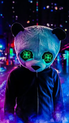 a person wearing a panda bear costume in the dark with neon lights on their eyes