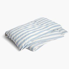 two blue and white striped pillows sitting on top of each other next to each other