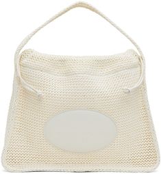 Polypropylene raffia top handle bag in off-white. · Fixed shoulder strap · Leather logo patch at face · Drawstring closure · Two-compartment interior · Unlined · H12 x W15 x D4 Supplier color: Off white Designer White Bag With Round Handle, White Shoulder Bag With Round Handle, White Travel Bag With Round Handle, White Shoulder Bag With Round Handle For Travel, Designer White Shoulder Bag With Braided Handles, Modern White Shoulder Bag With Braided Handles, Alexander Wang Bag, Satin Bags, Raffia Bag