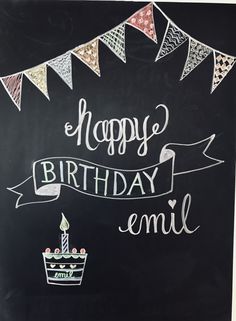 a chalkboard sign that says happy birthday emil with buntings and a cake