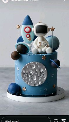 a blue cake with an astronaut on top and stars around the space in the middle