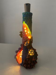 a colorful vase with lights on it sitting on a table