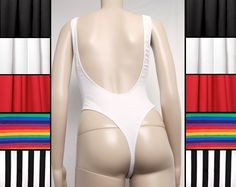 "Peitho Black's 90s cut bodysuit features a low back, high cut thong and sideboob cutouts. Choose from solid black, white, red, rainbow stripe (stripes approx 3/4\" wide) or black/white stripe (stripes approx 1.5\" wide). Rainbow stripe will be horizontally oriented, black/white stripe vertically oriented unless otherwise specified! All are 92% cotton, 8% spandex, which makes them fantastic for fire spinning and other burner, festival, or circus activities. (Other colors and prints are available 90s Bodysuit, Circus Activities, Fire Spinning, 90s Cut, Fire Play, Fire Safe, Cotton Bodysuit, High Leg, Rainbow Stripes