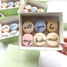 three boxes filled with different types of macaroons