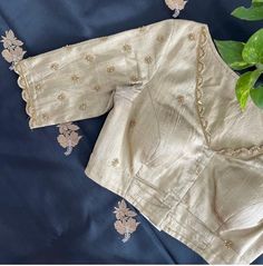 Hand embroidered ready made saree blouse / crop top/stitched saree blouse usa / white saree blouse/modern blouse/zardosi blouse/cream saree blouse/ pure silk blouse/ maggam work blouse        It is very true that a perfect blouse is the one which makes your saree look stand out !! If you find one of such a style that you have been wanting to have then dont let it go !! we carry such unique trending blouses that instantly add a stylish look to any saree !!      Here is a beautiful Hand embroidered zardosi work saree blouse in beige color that has V neck design front and back  emblished with gold and antique scallop embroidered on neck sleeves  front and back as shown!! Runs with any self or contrast color saree ! Please message us for any color / size customization !!  Fabric : pure raw sil Cream Color Blouse Maggam Work Designs, Cream Color Blouse Design, Scallop Embroidery Blouse, Cream Color Maggam Work Blouse, White Silk Saree Blouse Designs, Blouse Sleeve Embroidery Designs, Navy Blue Saree Blouse Combination, Wedding Cotton Silk Blouse Piece With Dori Work, Wedding Tussar Silk Saree With Floral Embroidery