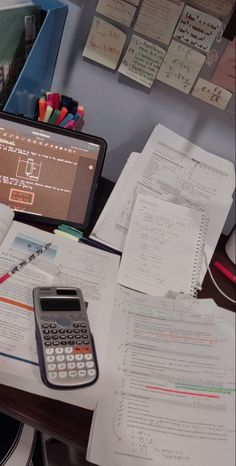 there is a calculator and some papers on the desk