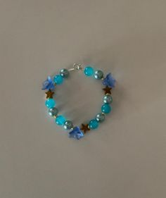 Handmade blue flowers bracelet Blue Flower Shaped Beaded Bracelet For Gift, Blue Bohemian Flower Bracelets, Bohemian Blue Flower Bracelets, Blue Jewelry With Flower Charm And Round Beads, Handmade Blue Flower Beaded Bracelets, Blue Beaded Flower Jewelry, Handmade Flower Shaped Blue Beaded Bracelets, Blue Flower-shaped Jewelry With Spacer Beads, Blue Flower-shaped Beaded Jewelry