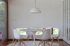 a dining room with white chairs and a table