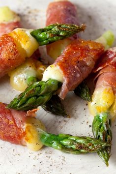 asparagus and ham wrapped in bacon on a plate