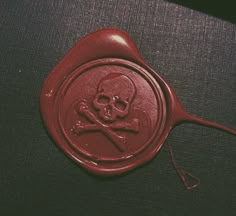 a wax stamp with a skull and crossbones on it