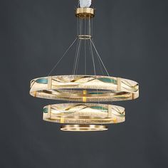 a chandelier hanging from the ceiling with two circular lights in front of it