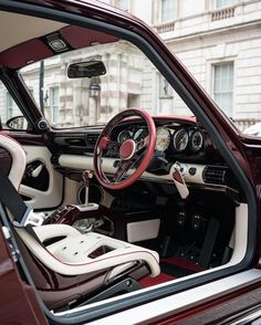 the interior of a classic car with red and white trim