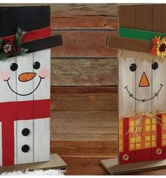 two wooden snowmen with hats and scarfs