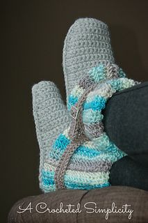 a pair of crocheted slippers sitting on top of a chair