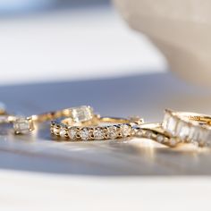 three wedding rings sitting next to each other on a table