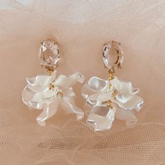 Emulating the ruffles on a ballerina, this earring is dainty, unique and completely weightless. The faceted stone brings light to your face and is extremely flattering. The ruffle like lines are feminine and flirty all at once. Earrings are handmade and turnaround time can vary up to 2 weeks Yellow Gold Flower Drop Earrings For Party, White Drop Earrings For Evening, Chic Flower Earring For Wedding, Elegant Faceted Chandelier Earrings, Chic Drop Wedding Jewelry, Elegant Pearl White Earrings For Party, Elegant Faceted Chandelier Earrings For Gifts, Delicate Dangle Earrings For Party, Chic Petal-shaped Earrings For Gift