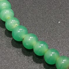 *Description: This necklace is made from faux jade green glass beads that have small air bubbles in them from the 1930s or before. They would be perfect to restring as they are most likely antique beads and the metal plated findings did not hold up as well as the glass beads. Unchecked from a gem tester, you would believe these to be jade but they are indeed glass. Looking closely with a loop, you can see the air bubbles within many of the glass beads. The necklace is 15 inches in length. This w Green Oval Jade Beads Jewelry, Green Chrysoprase Beaded Necklace With Gemstone Beads, Green Chrysoprase Gemstone Beaded Necklaces, Green Gemstone Beads Necklace In Chrysoprase, Green Rondelle Hand-strung Beads, Green Chrysoprase Beaded Necklaces, Green Oval Beaded Jewelry 8mm, Green Beaded Necklaces With 8mm Round Beads, Round Green Beaded Necklaces With 8mm Beads