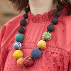 A constellation of colorful repurposed Kantha beads brightens up a background of black beads, representative of the night sky. Sustainably handmade by women artisans in India.