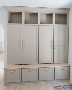 an empty room with some cupboards and drawers on the wall in front of it