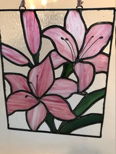 a stained glass window with pink flowers on it